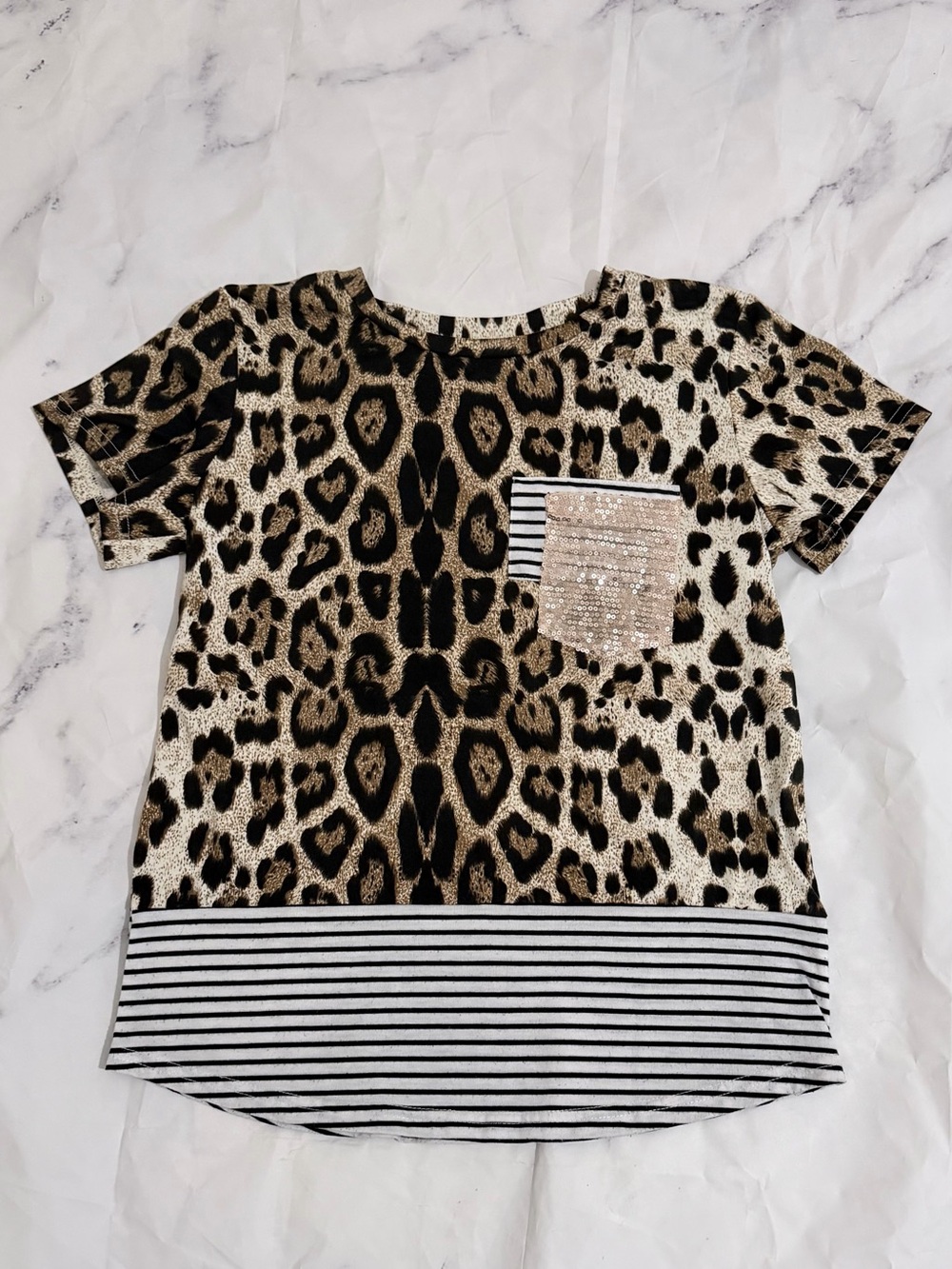 Women’s cheetah print shirt with white stripes and a sparkly gold pocket